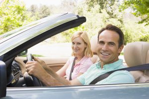 man and woman in convertible automobile