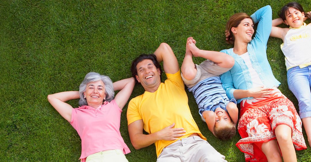 family lying on lawn